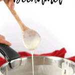 Bechamel dripping from a wooden spoon