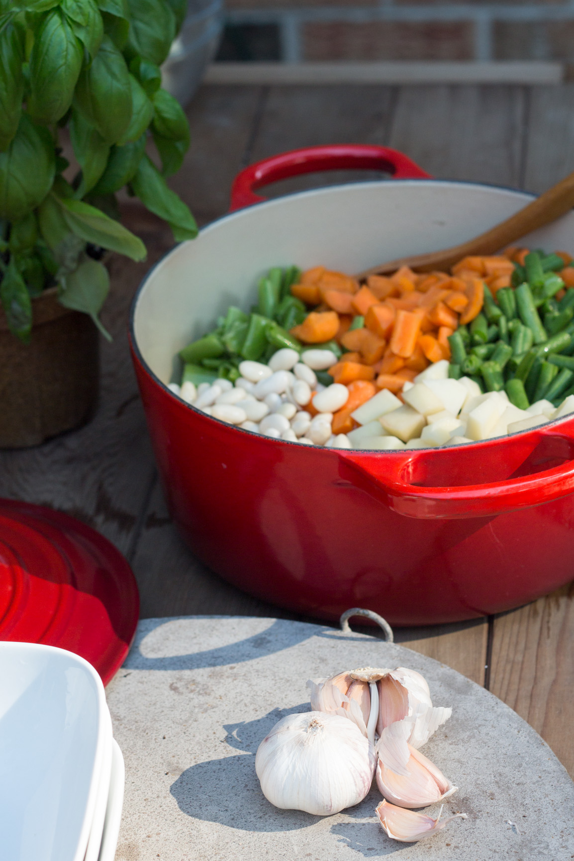 Red pot with all the beans for Pistou soup and garlic