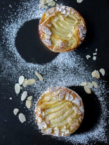View from above of French tart Amandine: a delicious flaky crust with an almond cream filling and a juicy pear.