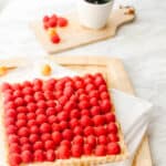 Side view of a raspberry tart with french vanilla pastry cream filling