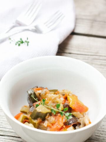 White bowl with easy french ratatouille on a wood background