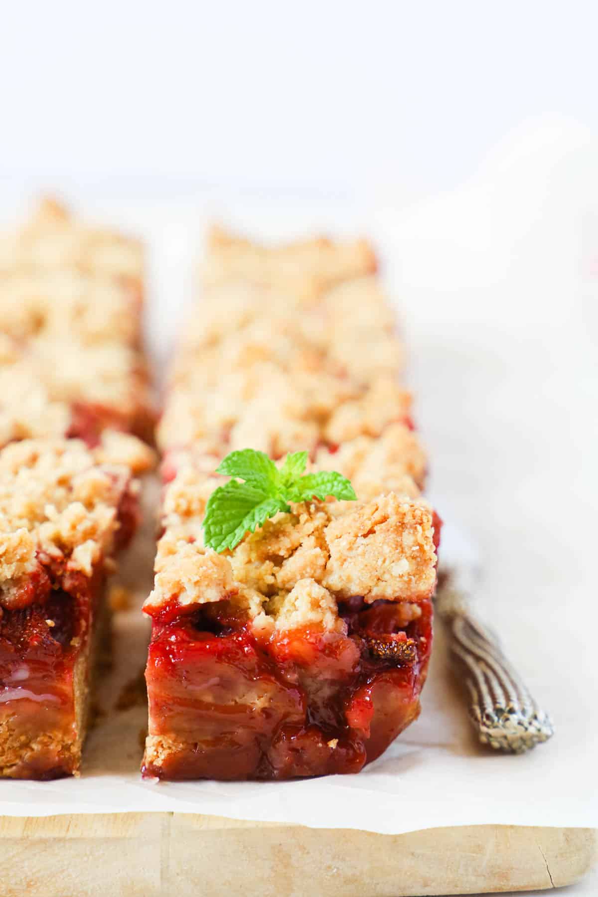 strawberry crumble bar with a small mint leaf of top.