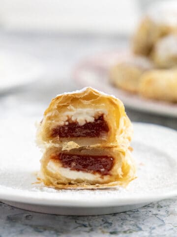 Side view of a sliced pastelitos de guayaba showing the cream cheese and the guava paste