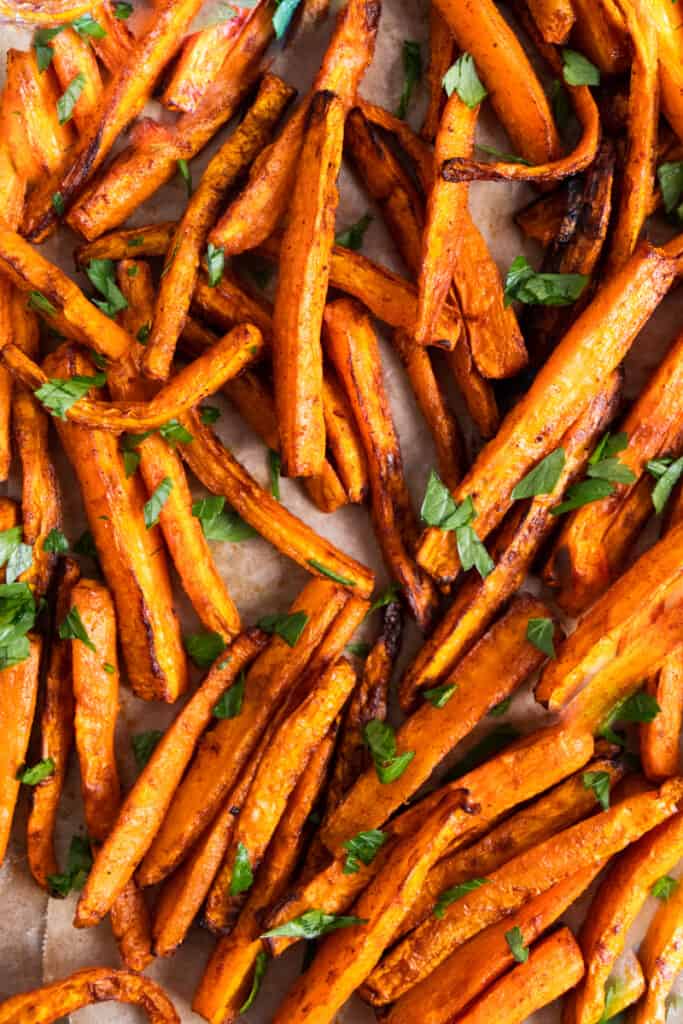 close up on carrots fries with chopped cilantro on top