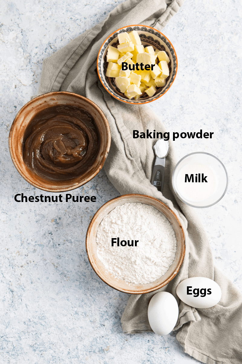 top view of the ingredients: chestnut puree, flour, eggs, milk, butter and baking powder. All labelled. 