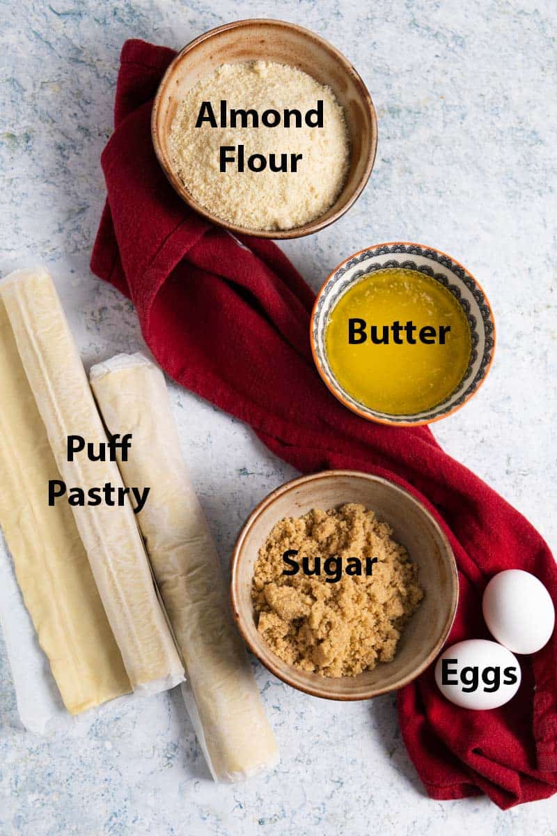 Top view of the ingredients needed for a King cake: almond flour, butter, puff pastry, sugar and eggs. 