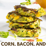 stack of 4 zucchini, corn and bacon fritters on a white plate with a dolop of sour cream on top.