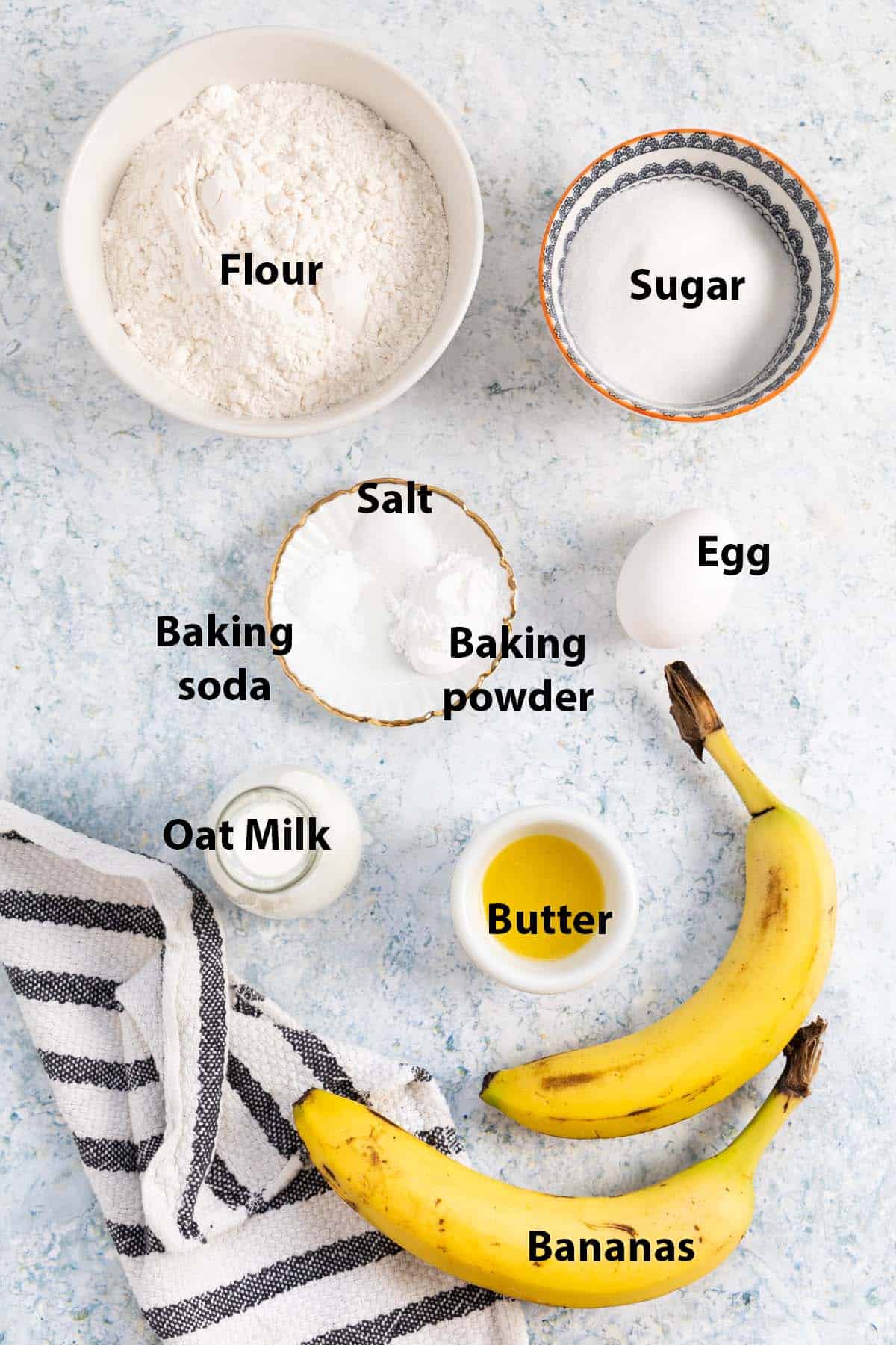 ingredients labelled: ripe banana, butter, oat milk, flour, baking soda, egg, baking powder, salt and sugar. 