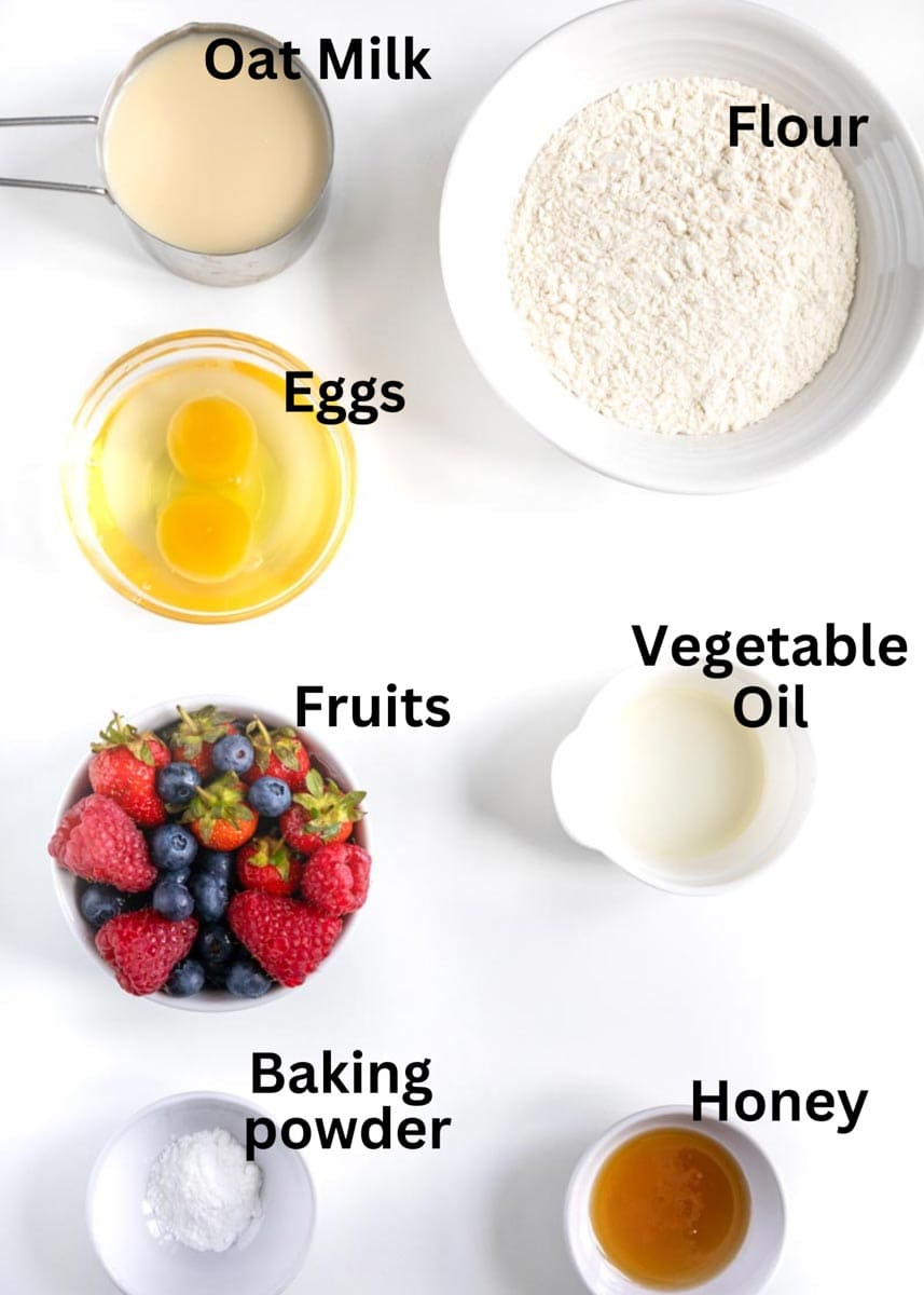 labelled ingredients in ramekins: flour, oat milk, eggs, fruits, vegetable oil, honey and baking powder. 