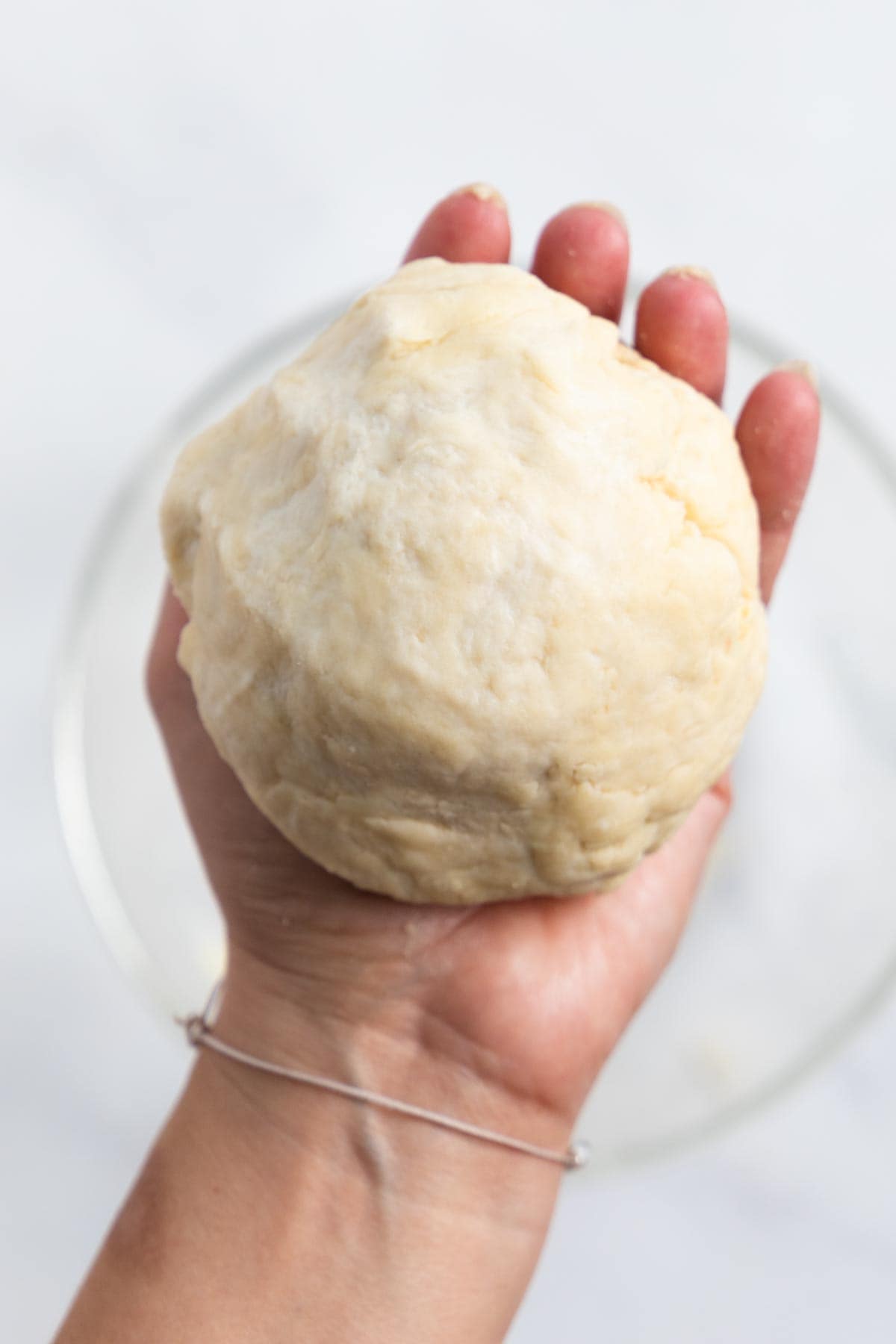 hand holding a ball of dough.