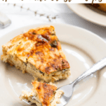 pin slice of quiche on a beige plate and a piece in a fork.