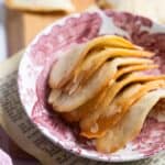 almond tuiles stacked in a shallow pink and white dish.