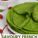 green crepes stack and cherry tomatoes spread around.